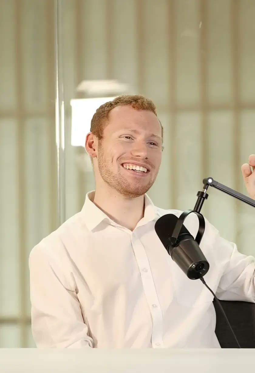 Joseph Carey at the microphone, smiling