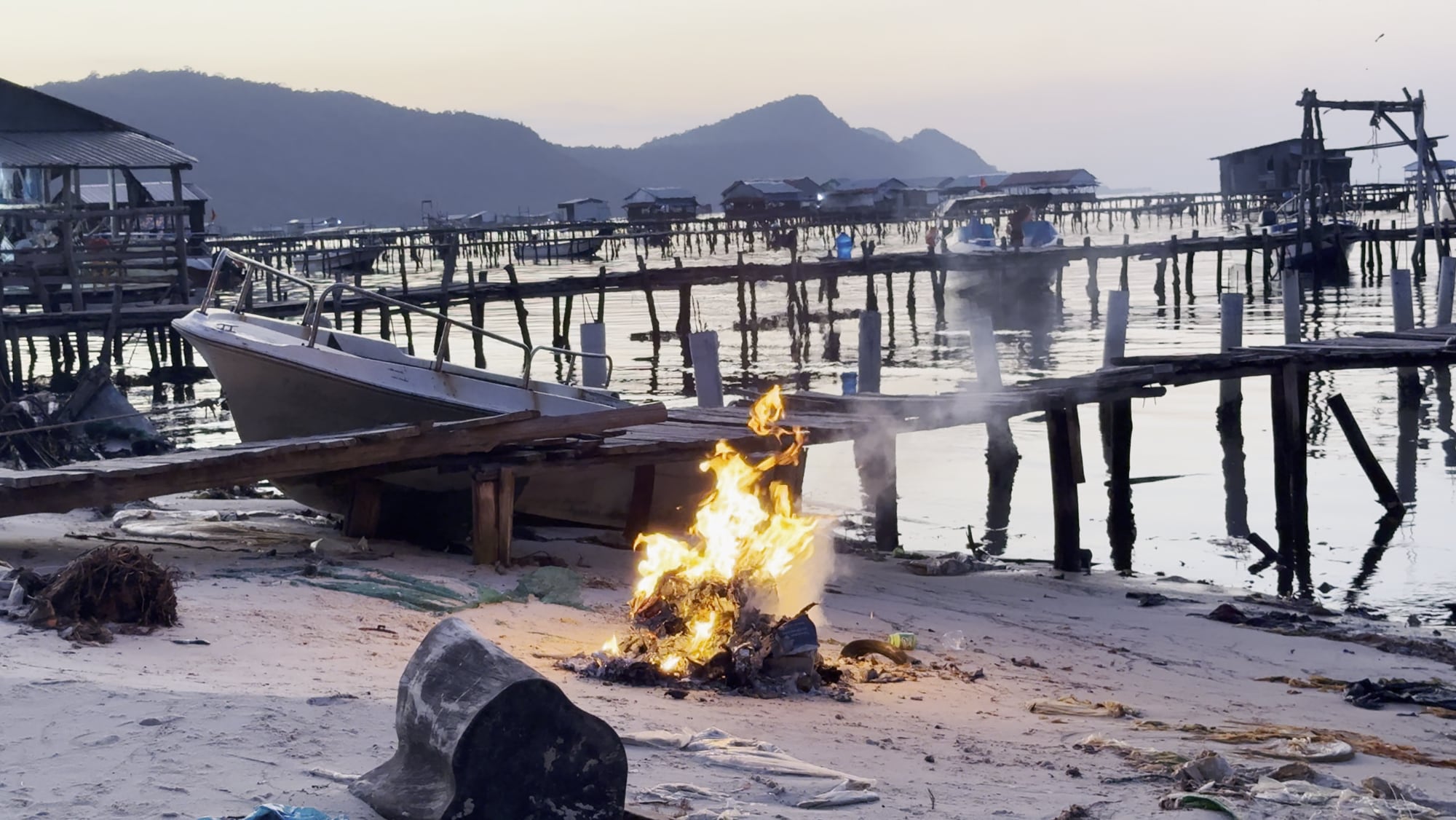 On the road, 2025: A fire on the beach at dusk, Phu Quoc