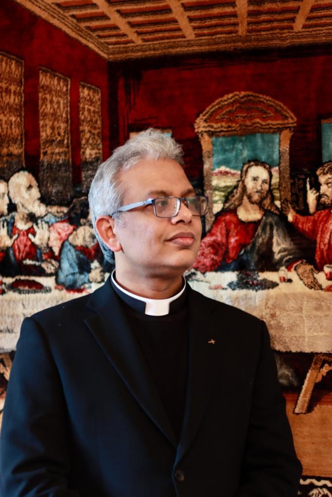 Portraits: In front of a Last Supper tapestry