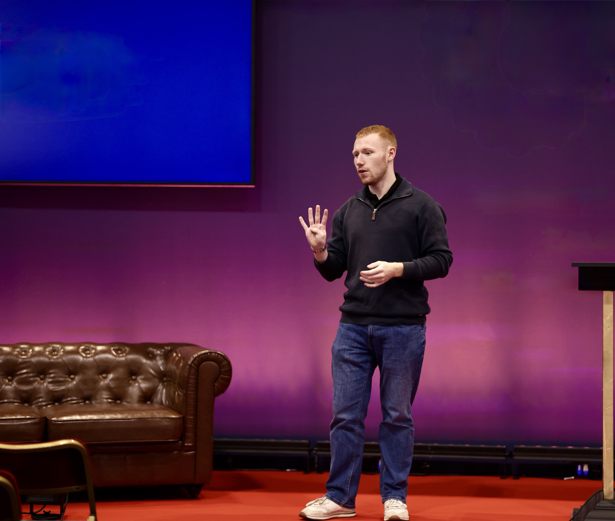Joseph Carey speaking on stage